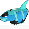 A bright turquoise dog life jacket with a fin, featuring blue and black accents.