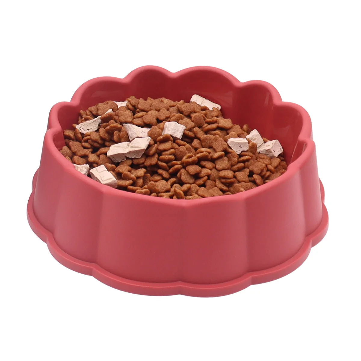 A pink non-slip pet feeding bowl filled with brown kibble and white pieces.