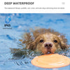 A dog is swimming in water near an orange floating disc, demonstrating the waterproof design of a training collar.