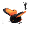 A black and orange butterfly cat teaser toy with a dangling cord.