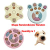 A set of interactive dog slow feeder puzzle toys in various shapes and colors with a small dog.