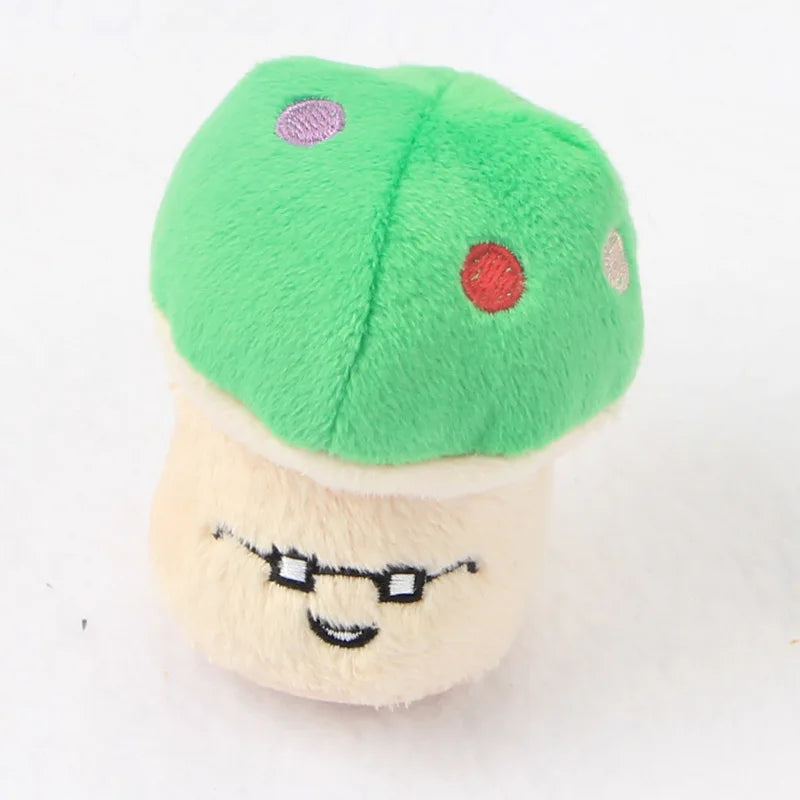 A cute plush toy shaped like a mushroom with green cap and a beige body, featuring small decorative dots.