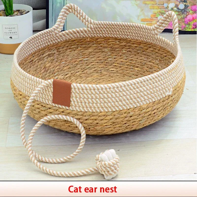 A woven rattan cat ear nest with a removable cushion and attached string.