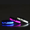 A reflective LED dog collar displaying three light modes: blue, magenta, and white.