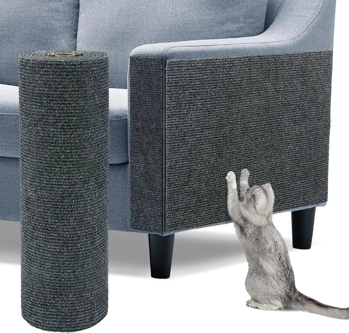 A gray cylindrical cat scratch pad is shown next to a grey upholstered sofa with a cat sitting on the floor.