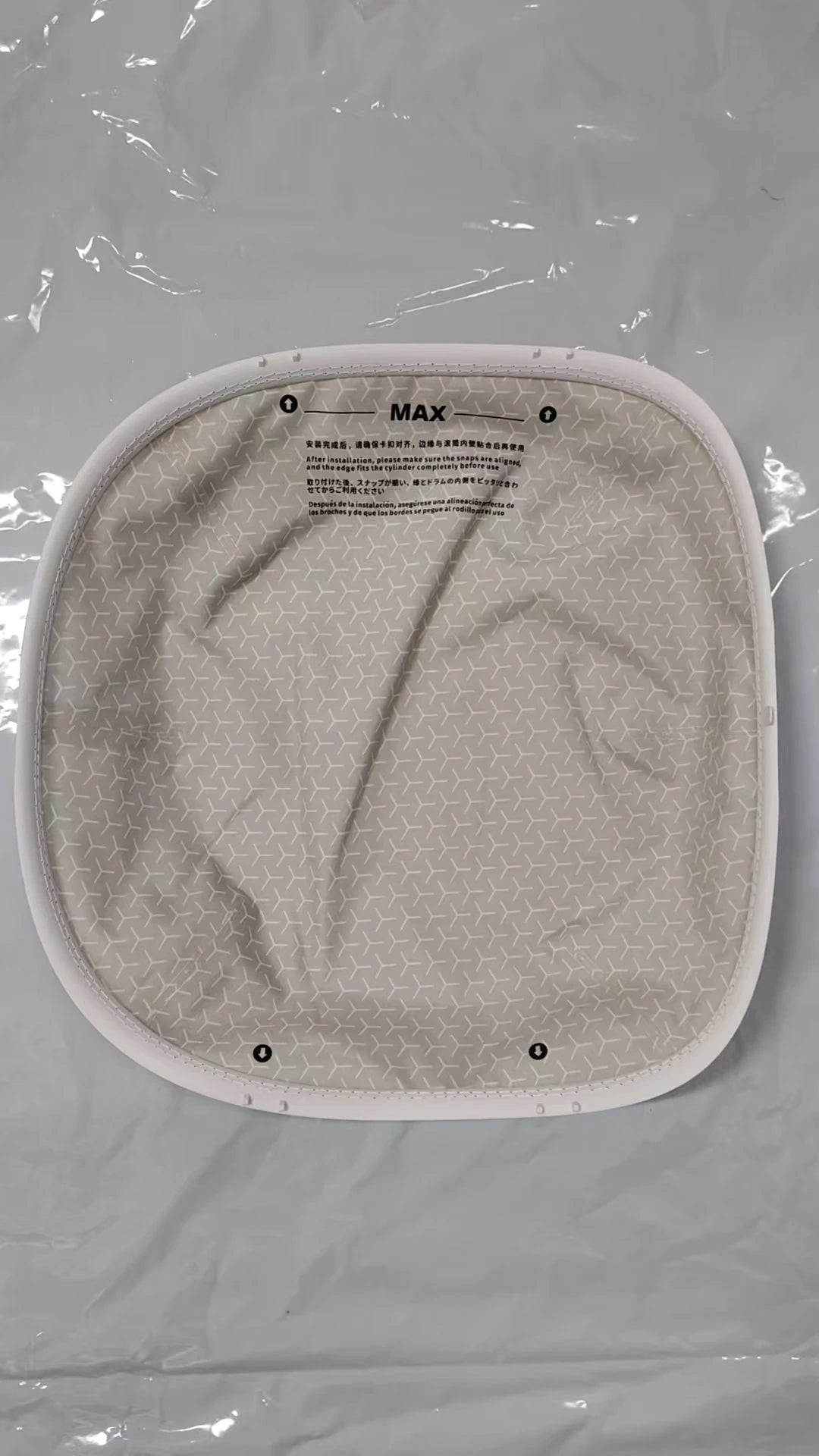 A white cat litter box mat with a textured surface and markings for use.