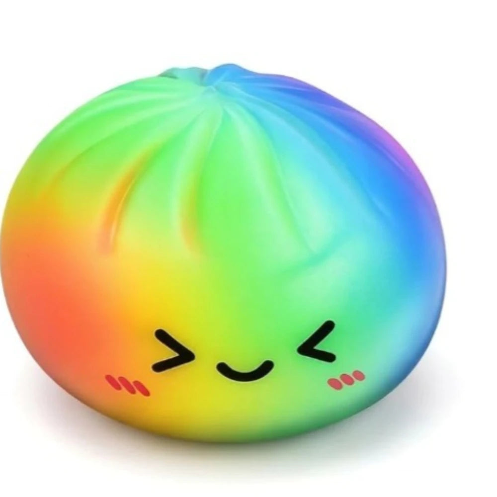 A brightly colored, translucent squishy toy shaped like a dumpling with a face, displaying a rainbow gradient of colors.
