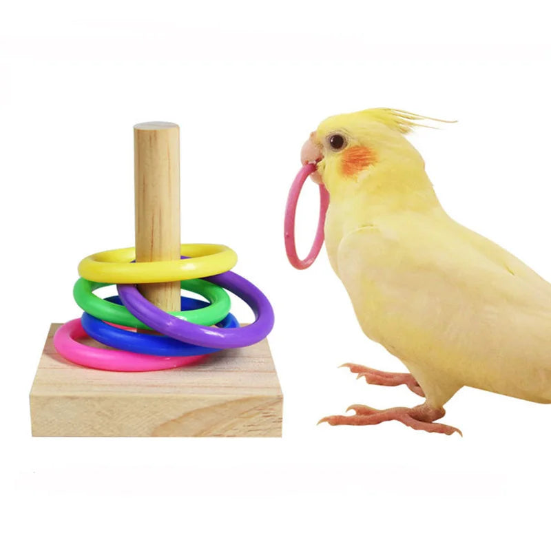 A yellow bird toy is shown next to a stack of colorful wooden rings.