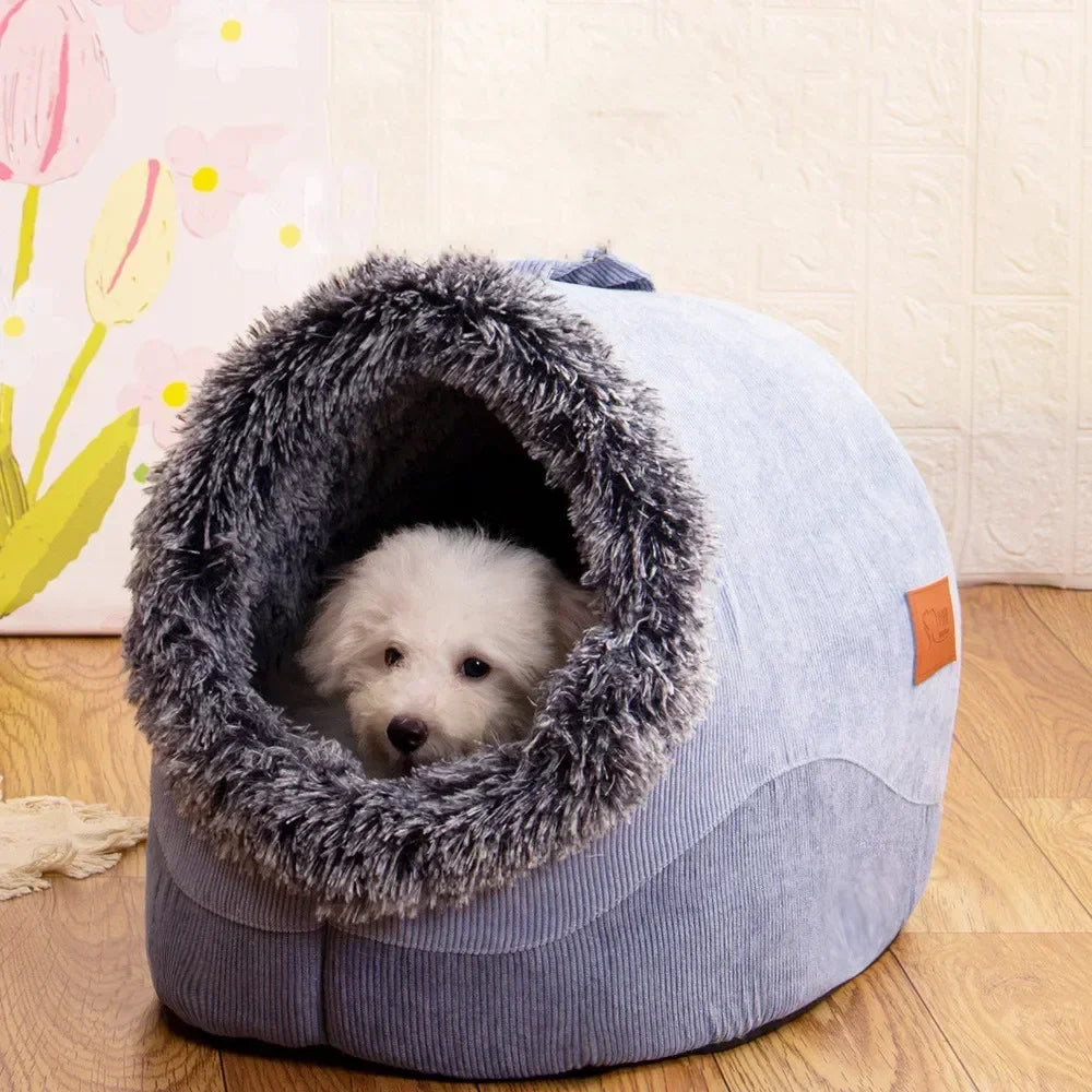 A gray plush pet nest bed with a furry entrance, sitting on a wooden floor.