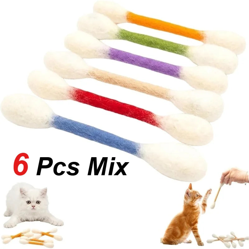 A mix of six white and colored catnip wands toys with chew ropes shown next to a kitten and a small cat.