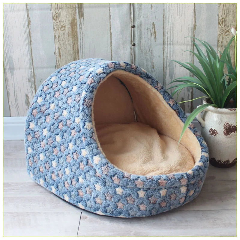 A round, textured blue and beige pet bed shaped like a cave for small and medium dogs.