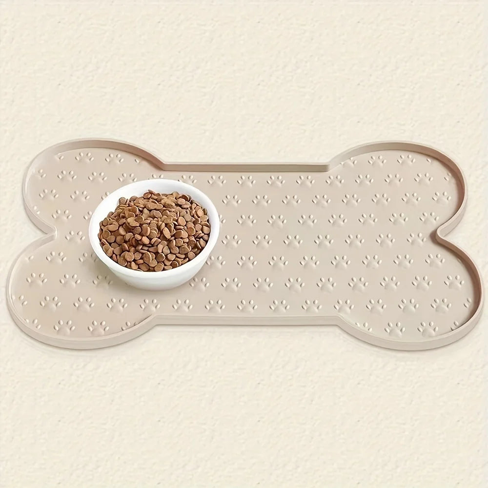 A beige silicone dog feeding mat with raised edges features a white bowl filled with seeds.