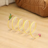 Yellow foldable S-shape cat tunnel with a suede finish lying on a wooden floor.