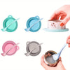 A set of pet food can lids and spoons in various shades of teal, pink, and gray.