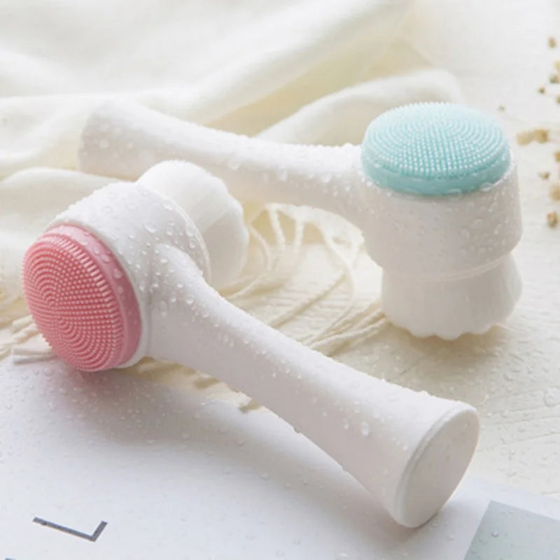 A white silicone pet paw cleaner and massage brush with pink and light blue bristles is shown on a white cloth.