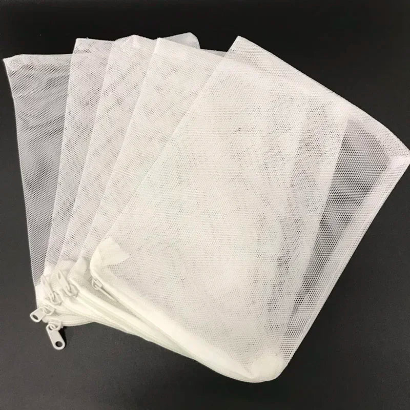 A stack of white mesh bags used for aquarium filter media.