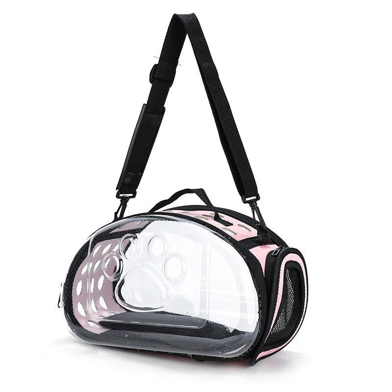 A transparent foldable pet travel carrier with a black shoulder strap.