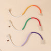 Three colorful cotton rope cat toys in yellow, green, and purple with tassels