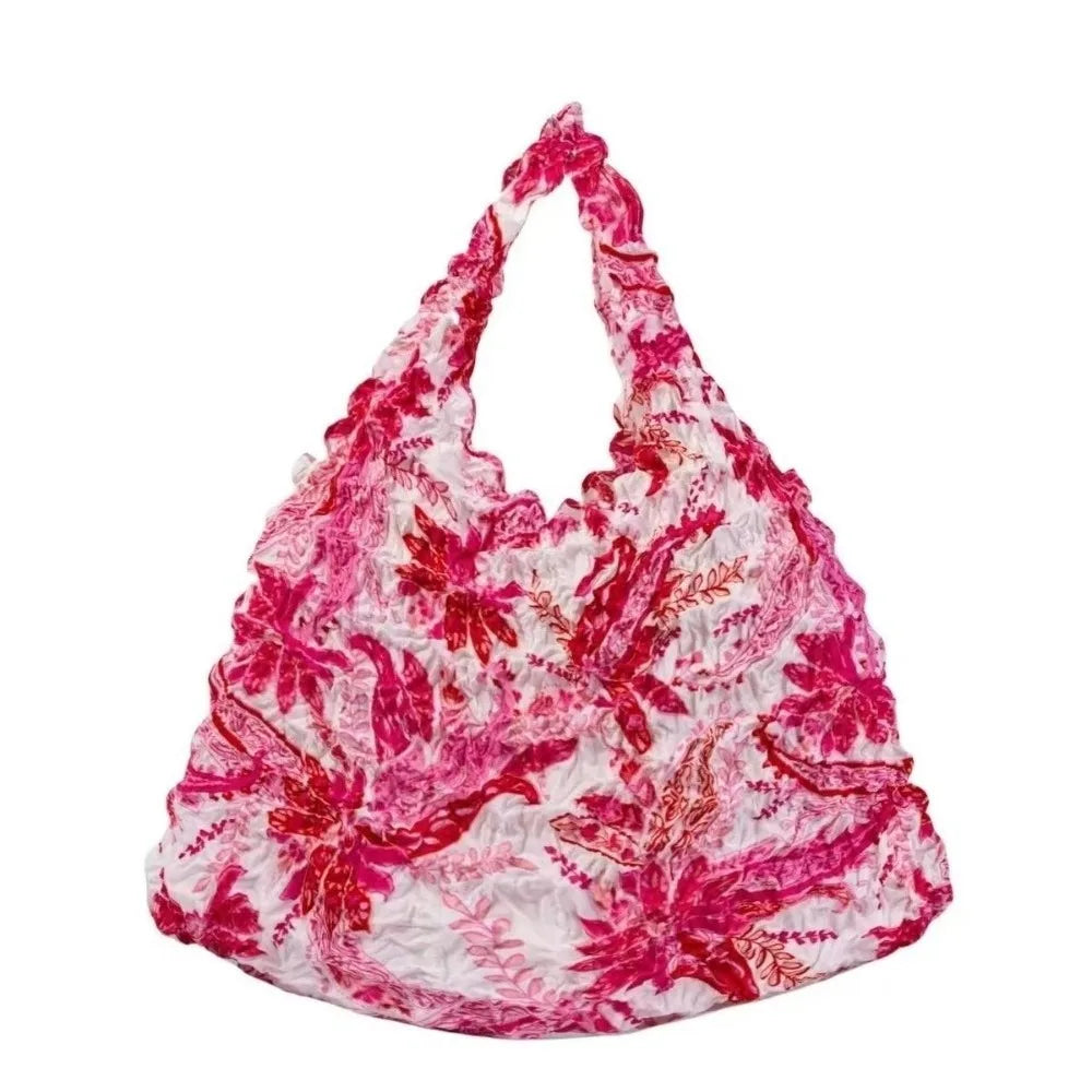 A pink and white floral patterned fabric tote bag