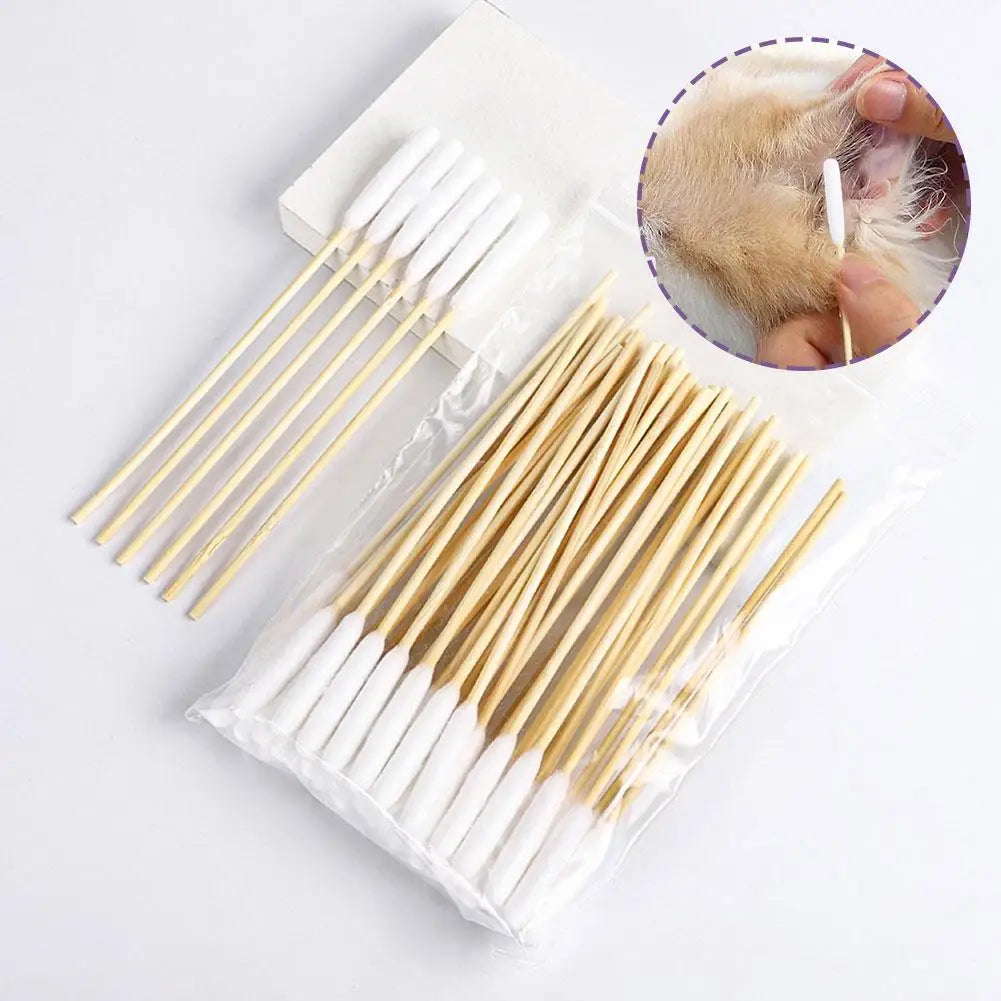 A clear plastic bag contains numerous wooden and white cotton swabs for pet ear cleaning, shown next to a close-up of a cat's