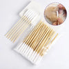 A clear plastic bag contains numerous wooden and white cotton swabs for pet ear cleaning, shown next to a close-up of a cat's