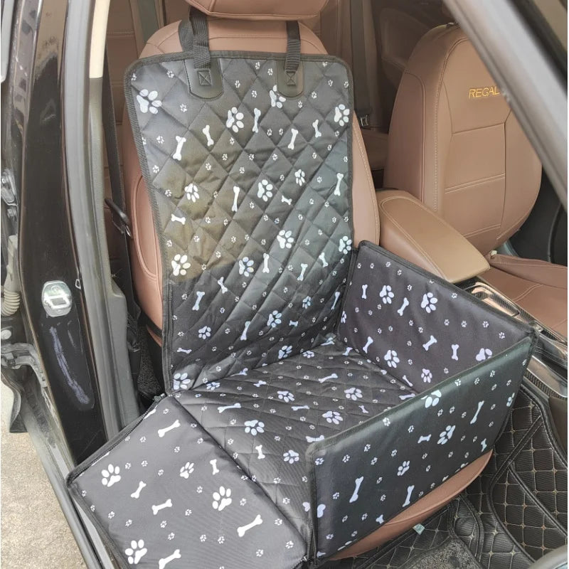 A black and white quilted waterproof dog car seat hammock installed in the back seat of a vehicle.