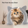 A fluffy orange kitten is sitting in a gray pet-free access door designed for cats.