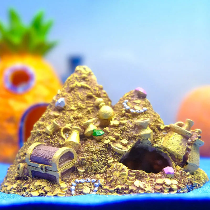 A small model of a mountain cave hideout decoration with a treasure chest design made of gold-colored material.