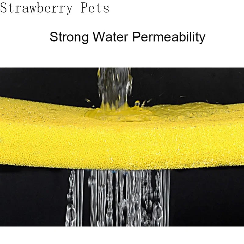 Close-up of a yellow, porous sponge filter demonstrating strong water permeability with water flowing through it.