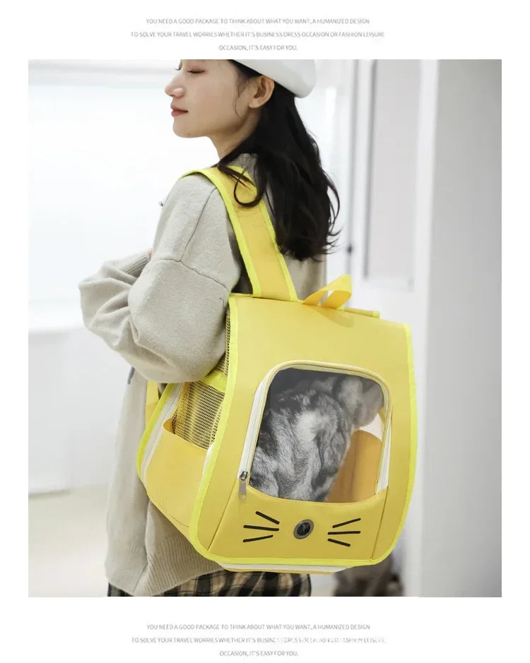A person is holding a yellow breathable pet carrier backpack designed for cats and small dogs.