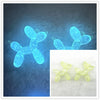 A pair of glowing blue acrylic balloon dog charms for jewelry making and keychains