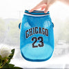 A bright blue pet dog basketball vest with the word CHICAGO and the number 23 printed on it.