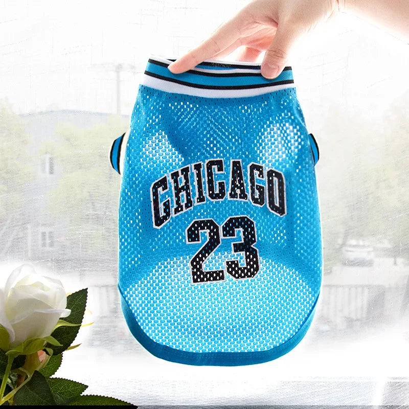 A bright blue pet dog basketball vest with the word CHICAGO and the number 23 printed on it.
