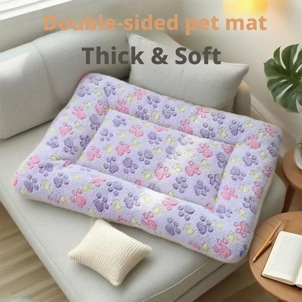 A purple and pink double-sided pet mat is displayed on a light gray sofa, showing its thick and soft texture.