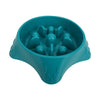 A teal slow feeder dog bowl with raised bumps for puzzle feeding.