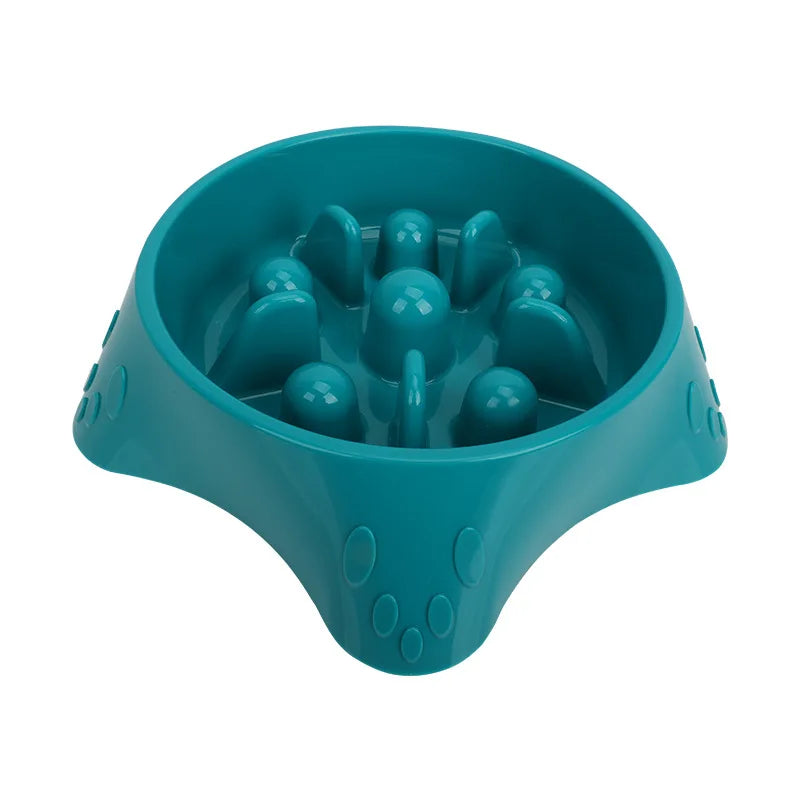 A teal slow feeder dog bowl with raised bumps for puzzle feeding.