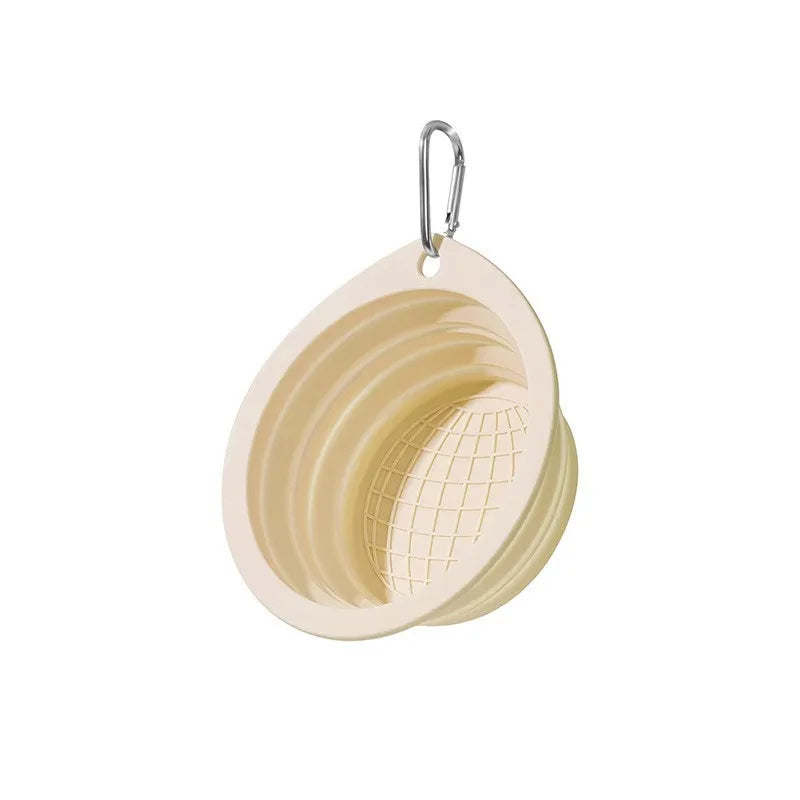A silicone pet travel bowl with a mesh insert and a hanging loop.