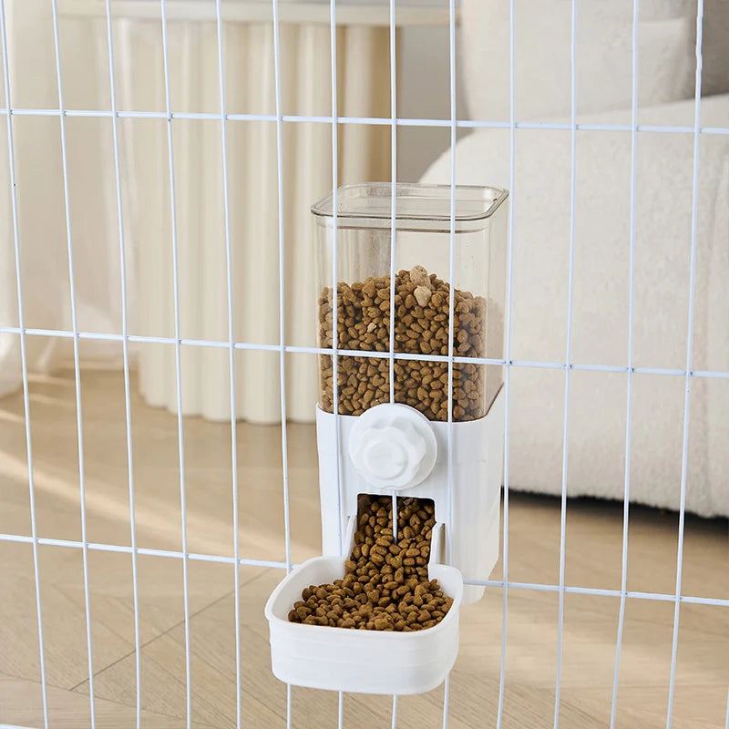 A white automatic pet feeder for dogs and cats is visible through a wire mesh barrier.