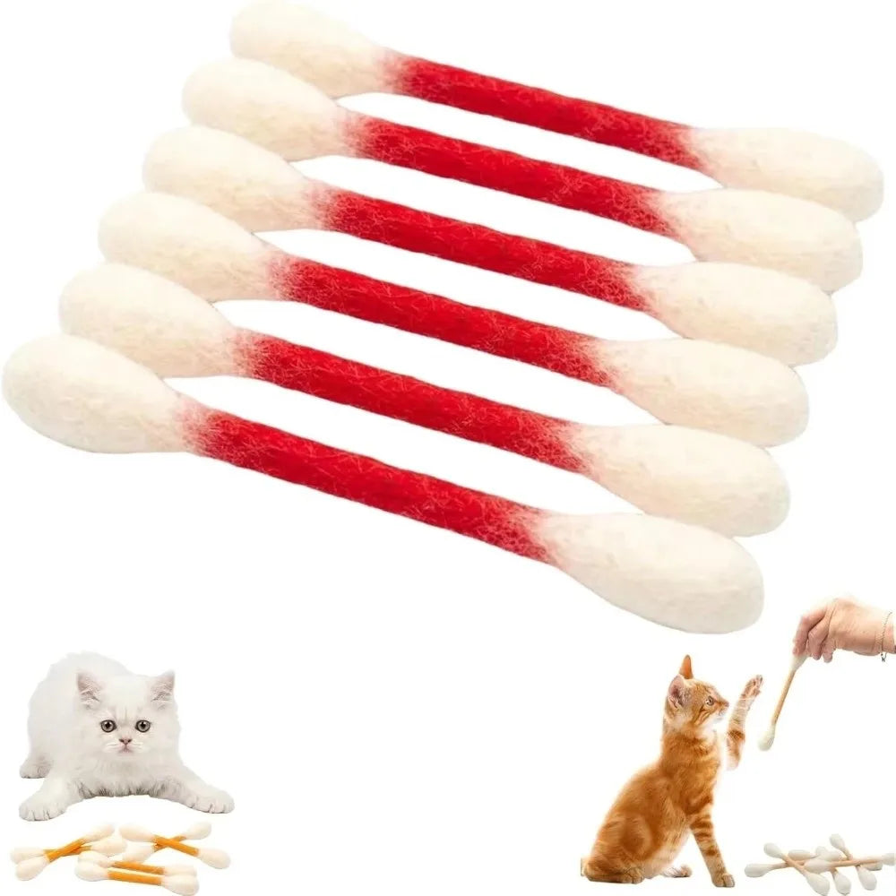 A pack of six red and white felt cotton swab cat toys arranged in a fan shape with a kitten nearby.