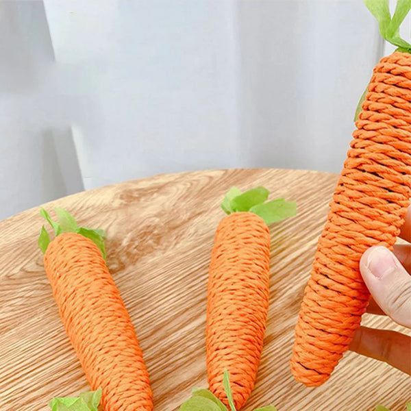 Orange yarn carrot cat toy coiled on a wooden surface