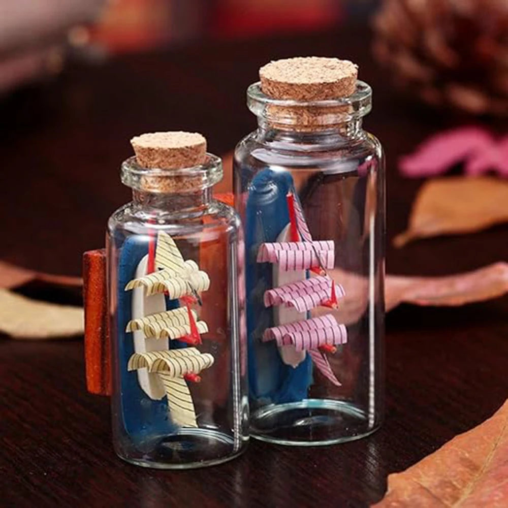 Two glass bottles filled with blue liquid and decorative cork stoppers, set against a dark wooden background.