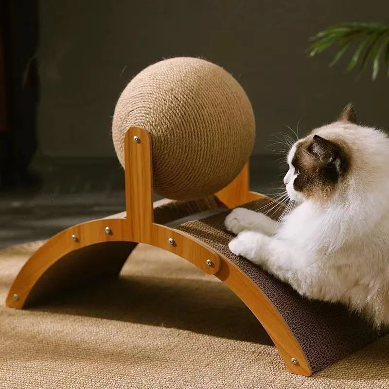 A white cat is relaxing on a wooden scratching board with a round sisal scratching ball.