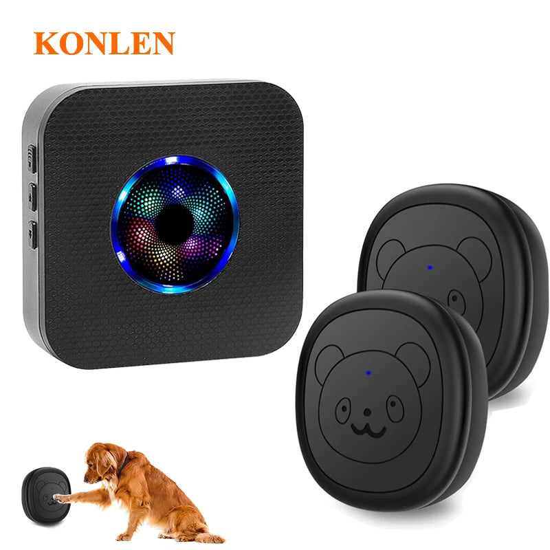 A black wireless dog doorbell with a circular light and a round training pad, next to a dog.
