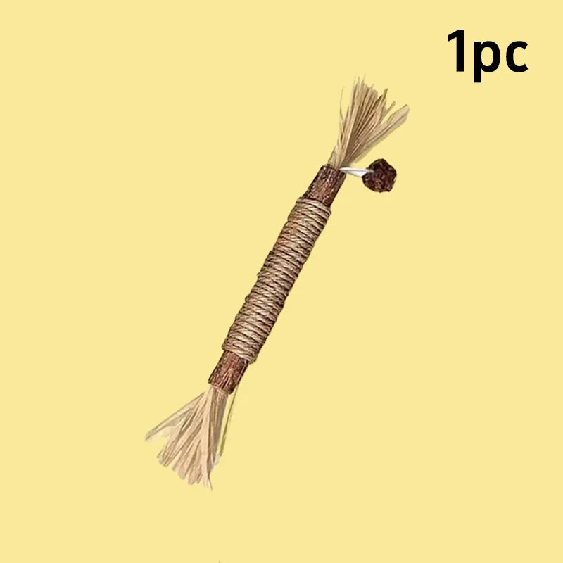 A brown catnip chew stick with a squeaker attached, shown against a beige background.