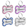 Silver and pink paw print shaped pet ID tags with the name Bauer engraved on them
