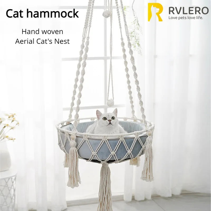 A hand woven cotton cat hammock with a cushion hanging from a stand for a pet.