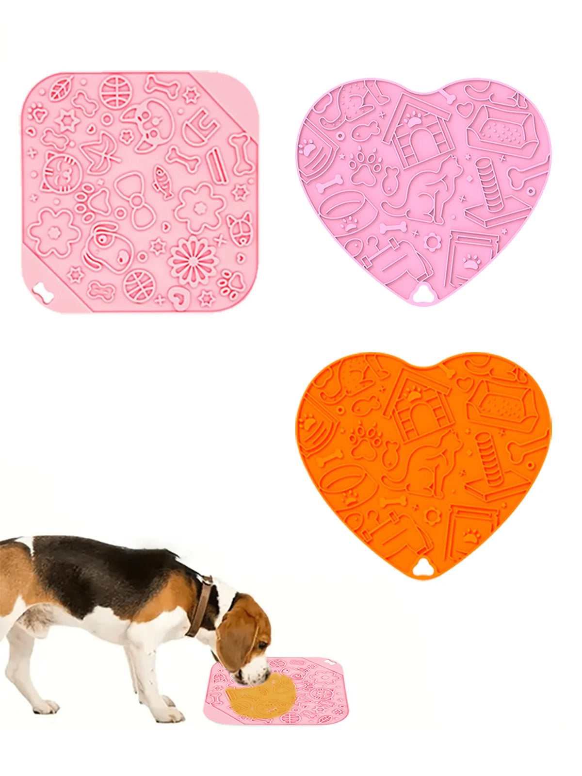 Pink and orange silicone interactive dog lick mats with various textures being used by a dog.