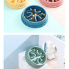 A set of silicone anti-choking slow feeder bowls for dogs and cats in various shades of green, yellow, and pink.