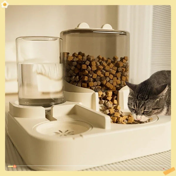 A white gravity pet feeder and water fountain set with dry food and water visible.