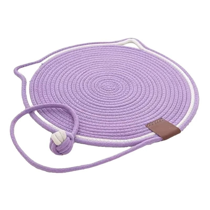 Purple cat scratching mat with a self-play ball
